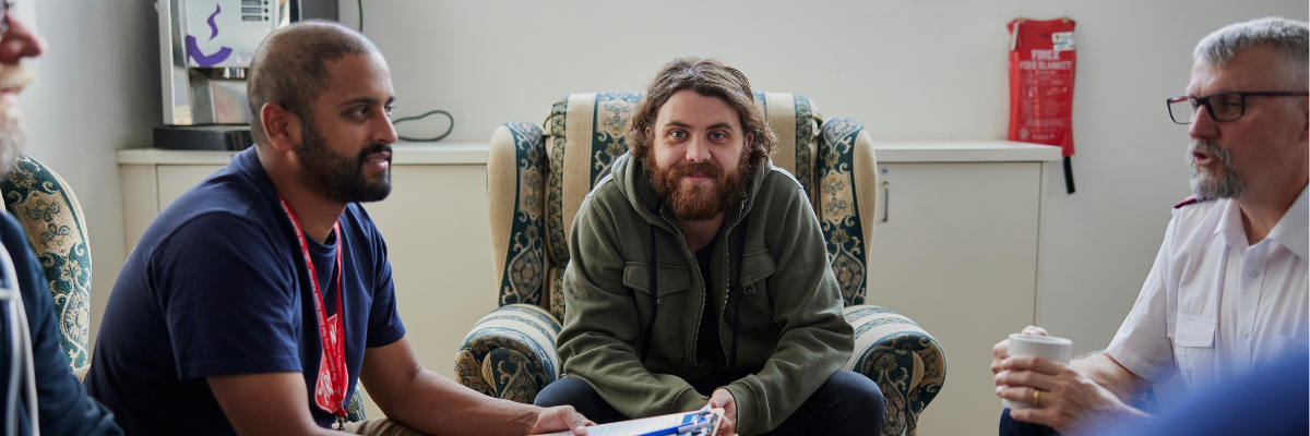 Homelessness week 2024 advocacy image of people sitting together 